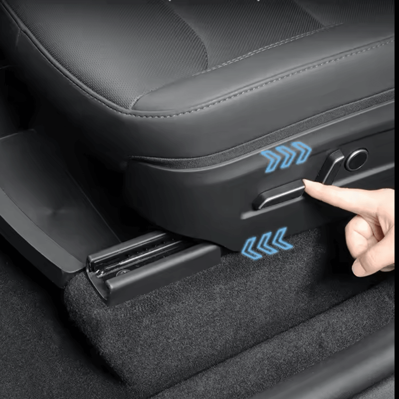 Close-up of a hand adjusting the seat mechanism in a Tesla Model Y, demonstrating seat positioning controls.