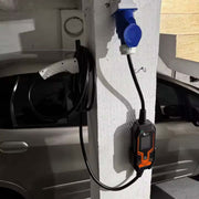 Wandhalter für EV-Ladestation CEE mit Typ 2 Ladegerät und Anschluss für E-Autos an einem weißen Pfeiler.