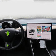 Tesla Model 3 interior with a rotating screen mount and digital display, featuring entertainment options and eco-friendly design.