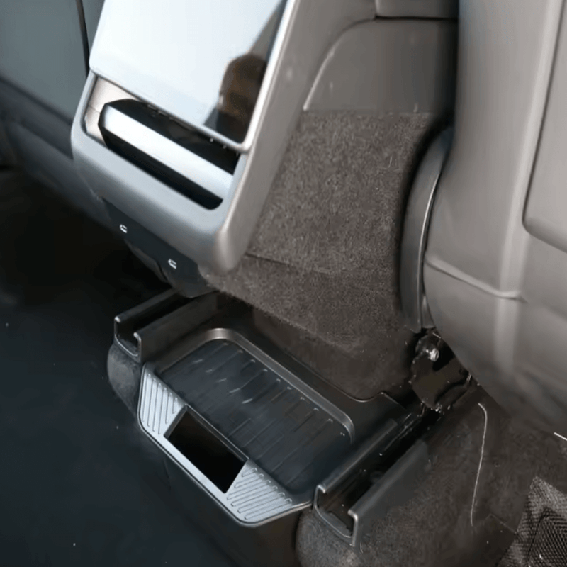 Organizer for rear center console in Tesla Model Y, providing extra storage and stability for items during drive.