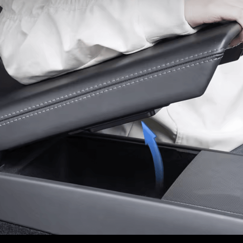 Person accessing a Tesla Model 3/Y armrest storage box, showcasing its convenient and discreet design.